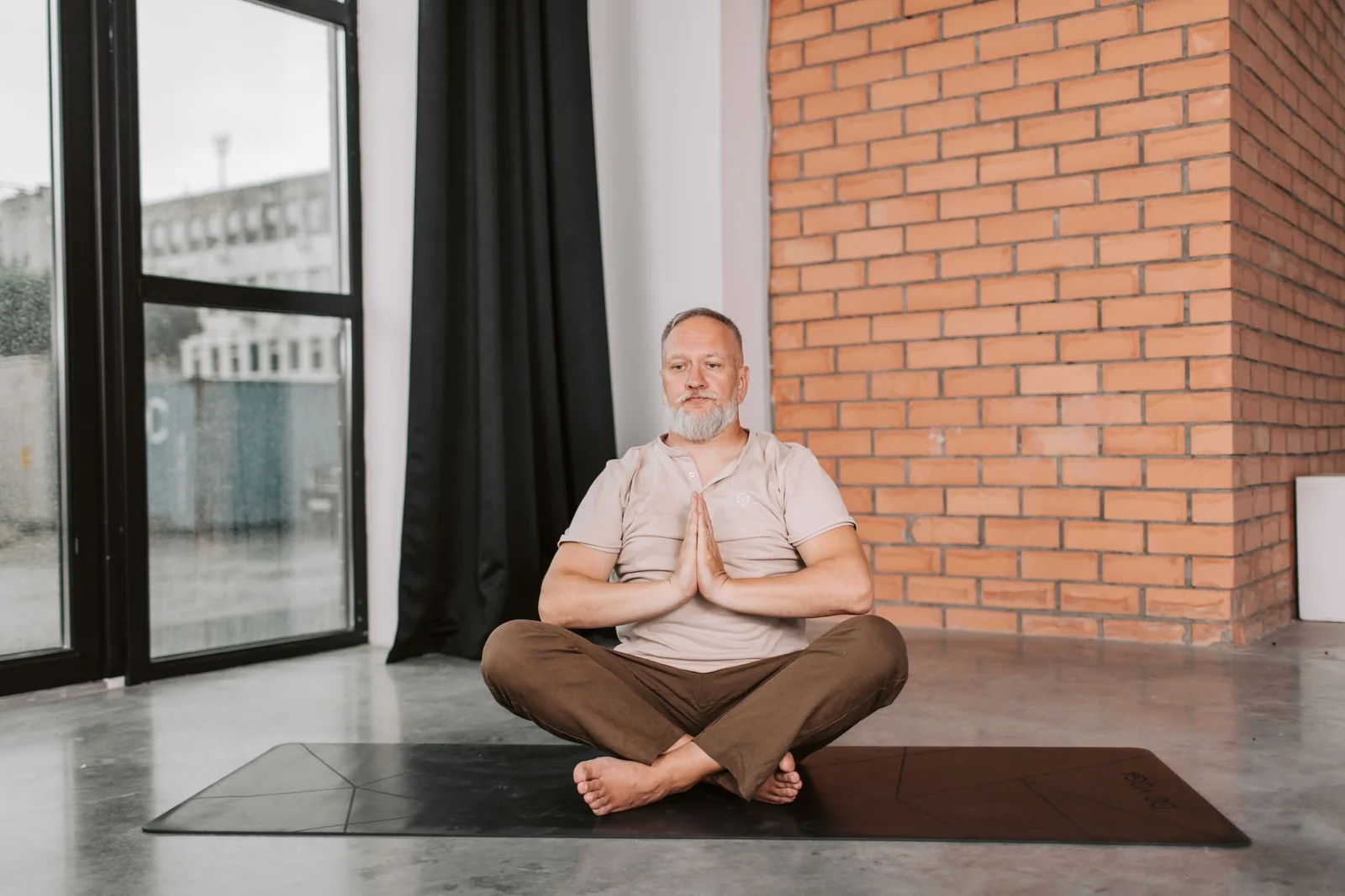 Mature man following a calm yoga and mobility routine